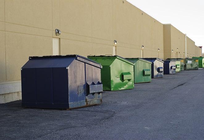 dumpsters are loaded up after the demolition of a building in Bedford